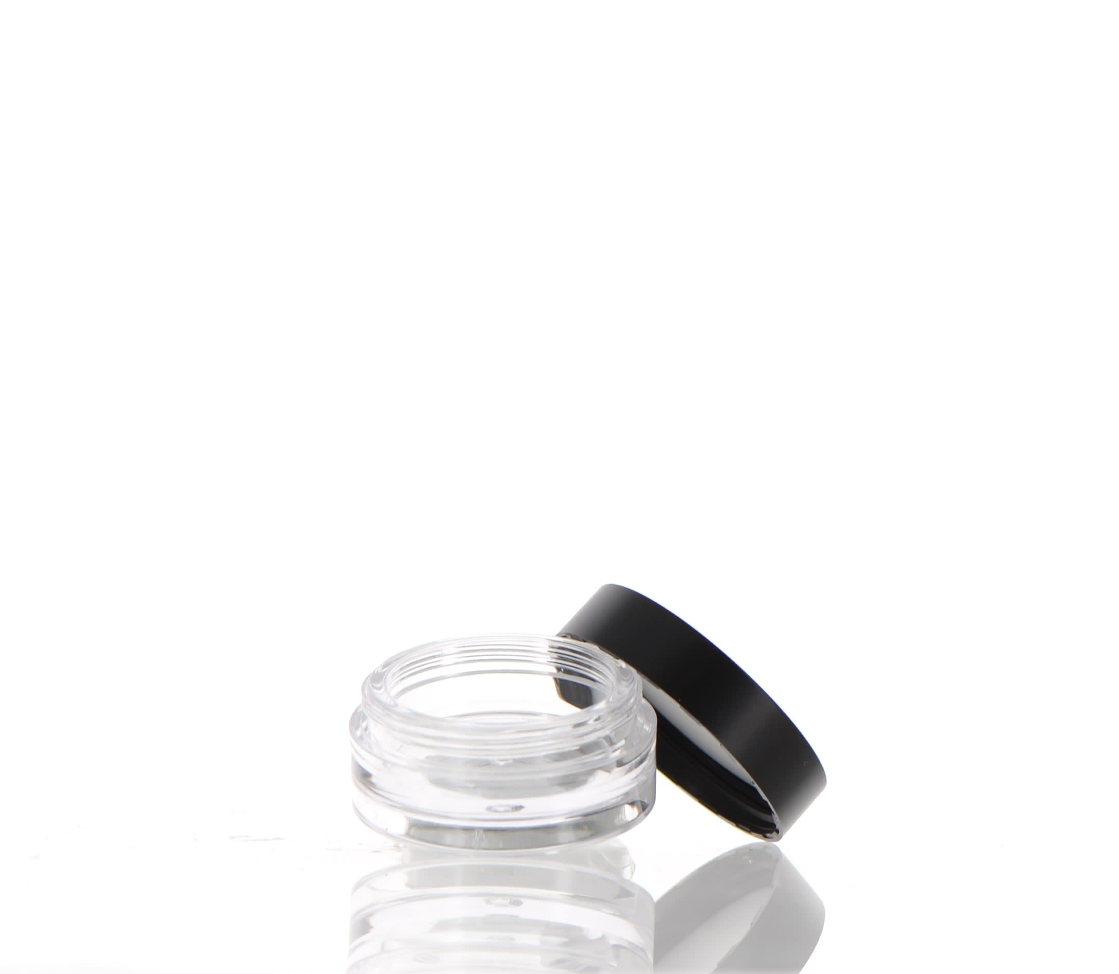 The image shows the APG Packaging 0.0oz Mixed Material Compact (APG-600077). It is a sleek, round compact case with a shiny, reflective surface. The compact appears to be closed, featuring a metallic finish with a smooth, polished look. The design is simple and elegant, making it suitable for holding cosmetic products. The compact's lid and base seem to be made of different materials, adding a touch of sophistication to the overall appearance.