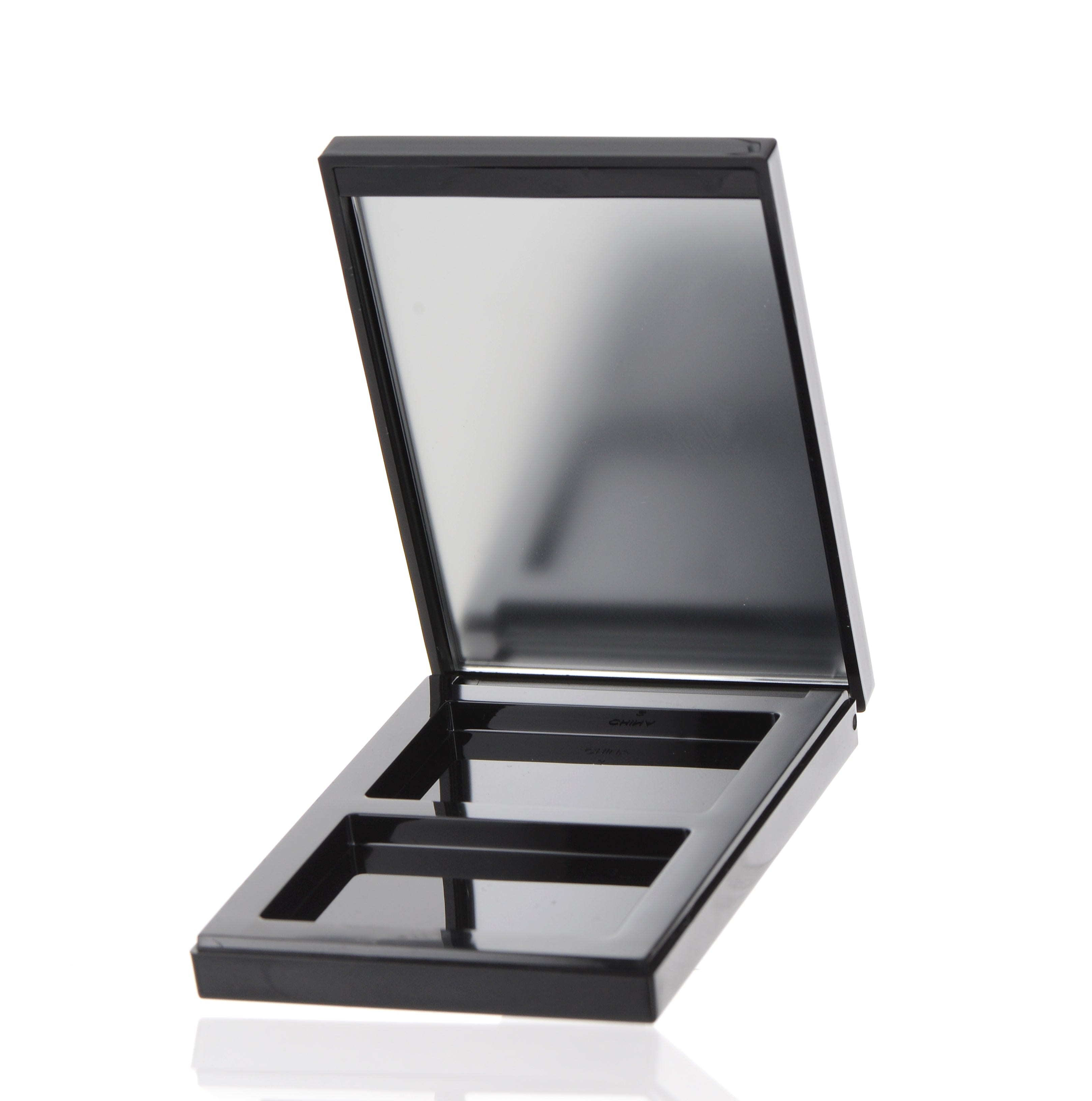 The image shows the APG Packaging 0.0oz Mixed Material Compact (APG-S045-B-BK). The compact is closed and features a sleek, round, black exterior with a smooth, glossy finish. The lid and base of the compact are slightly curved, giving it a modern and elegant appearance. The compact appears to be sturdy and well-crafted, suitable for holding makeup products.
