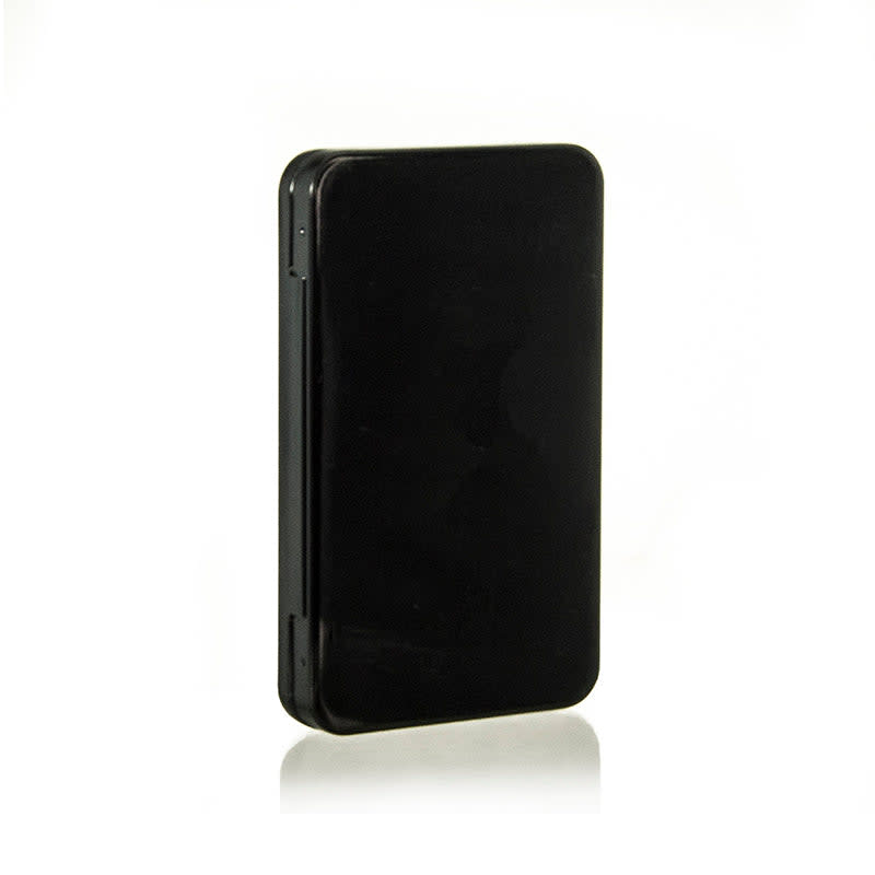 The image shows the APG Packaging 0.0oz Mixed Material Compact (APG-230). The compact is circular with a sleek, glossy black exterior. It features a hinged lid that appears to be securely closed. The compact's design is minimalistic and elegant, suitable for holding cosmetic products like powder or blush. The background is plain white, which highlights the compact's details and makes it the focal point of the image.