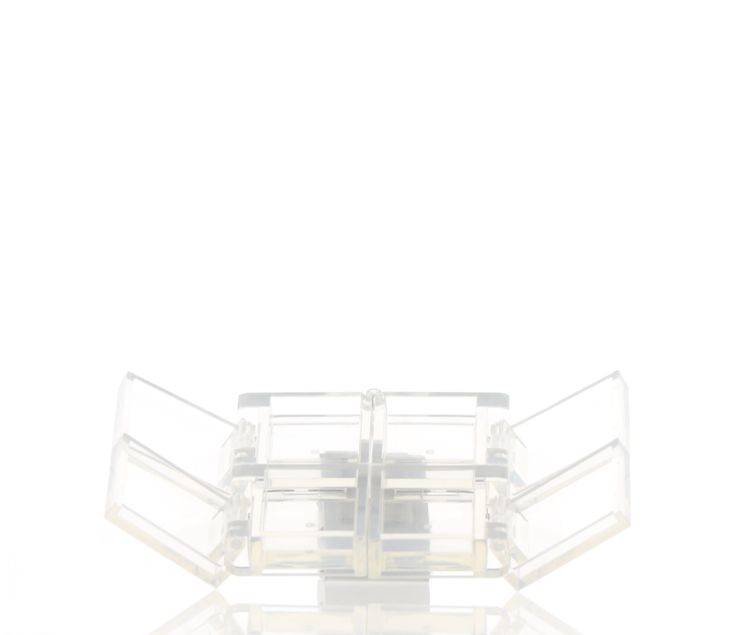 The image shows the APG Packaging 0.0oz PETG Compact (APG-400015). The compact is circular and appears to be made of clear plastic material. The lid is fully transparent, revealing an empty interior designed to hold cosmetic products. The compact has a sleek and minimalist design with smooth edges and a flat bottom, allowing it to sit upright. The overall appearance is modern and functional.