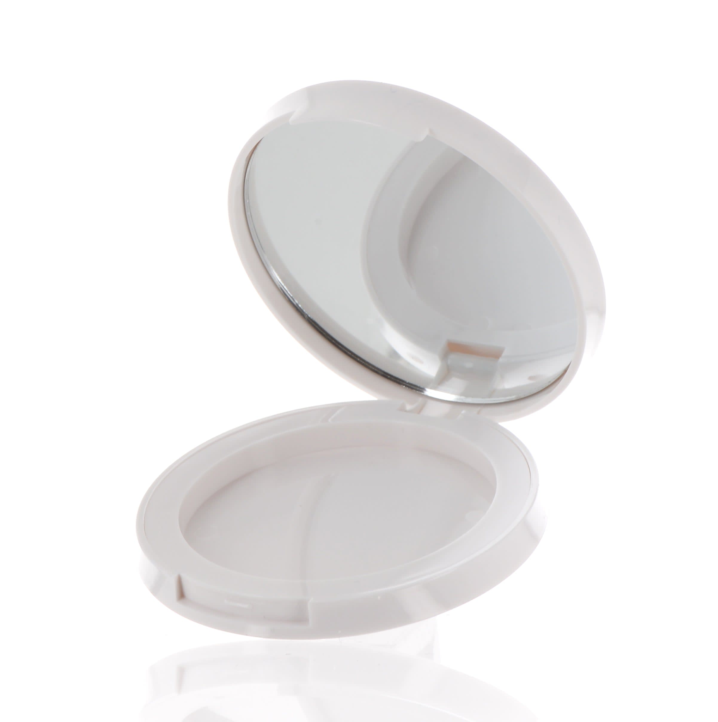 The image shows the APG Packaging 0.0oz Mixed Material Compact (APG-0462-WT). It is a sleek, circular compact case with a white exterior and a silver trim around the edges. The compact is open, revealing a mirrored lid and an empty compartment for holding cosmetic products. The design is minimalistic and modern, emphasizing the compact's elegant and clean appearance.