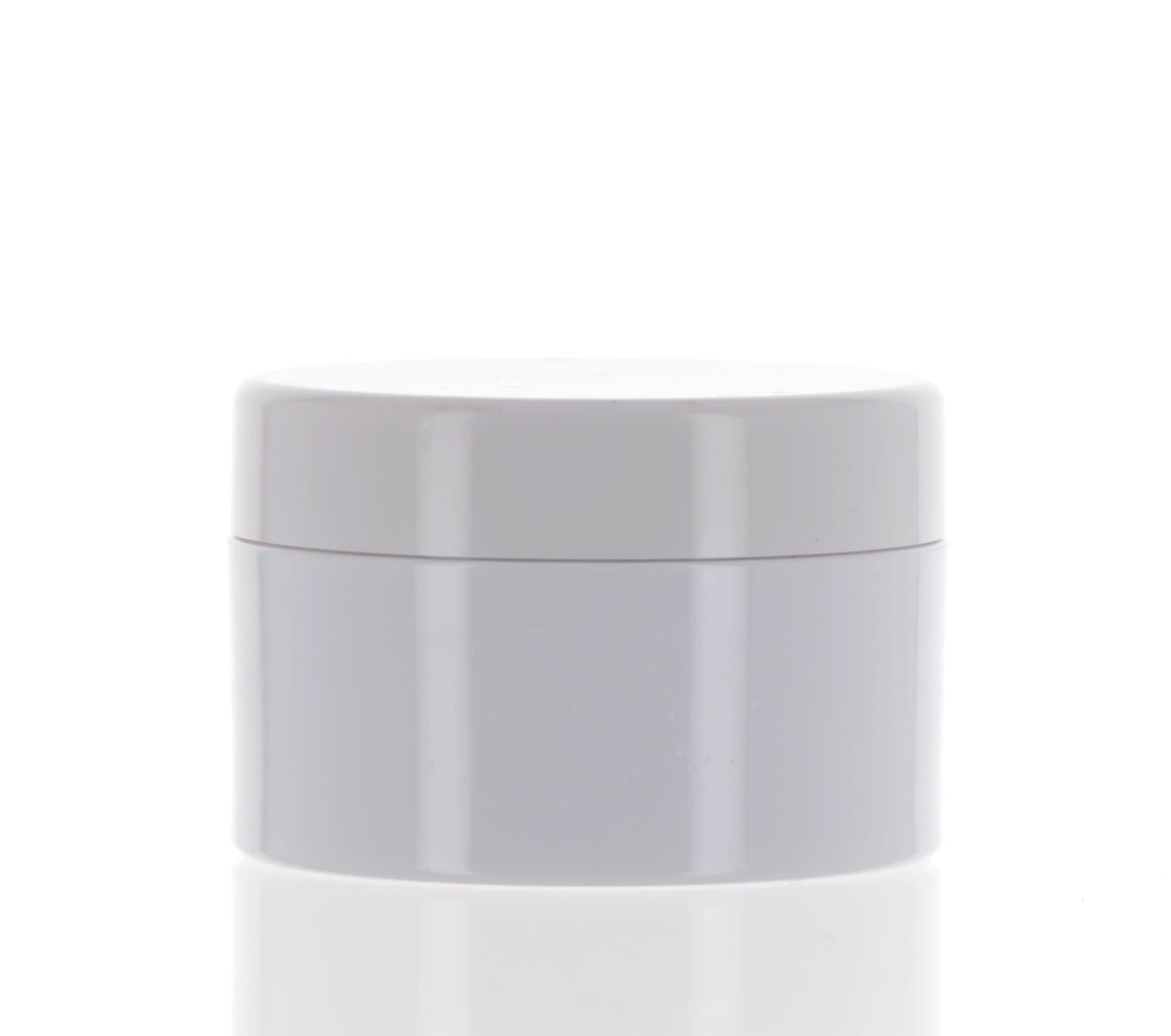 The image shows a small, clear jar with a black lid from APG Packaging, specifically the APG Packaging 1/4oz Mixed Material Jar. The jar has a simple, cylindrical design, and the transparent body allows for the contents to be visible. The black lid fits snugly on top, providing a sleek and modern appearance to the container.