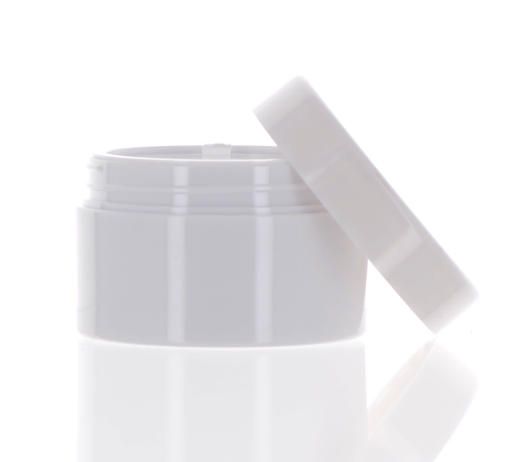 The image shows the APG Packaging 1/4oz Mixed Material Jar APG-2387-30. It is a small, cylindrical jar with a smooth, opaque white body and a shiny, reflective silver cap. The jar appears to be made of a durable material and is designed for holding small quantities of product, such as cosmetics or creams. The cap fits securely on top, giving the jar a sleek and modern appearance.