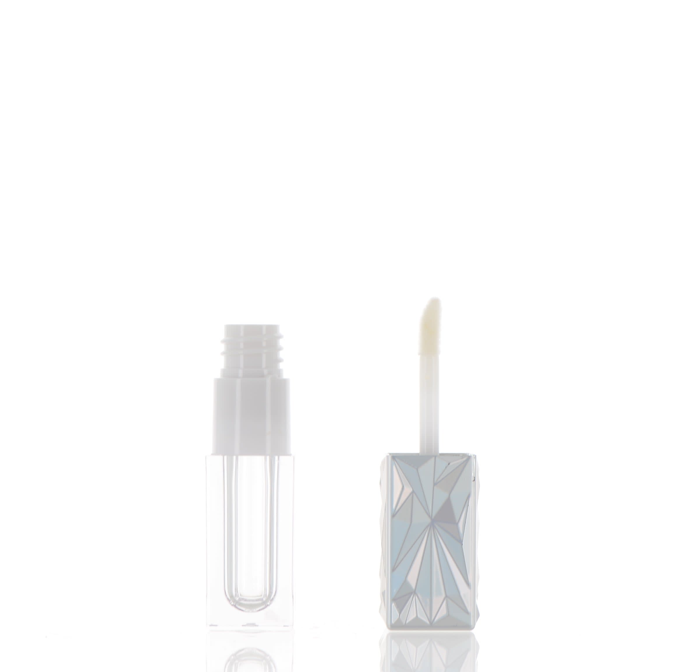 The image showcases the APG Packaging 0.1oz Mixed Material Lip Gloss Tube. The tube is sleek and cylindrical with a clear body that allows the product inside to be visible. It features a shiny metallic cap, which adds a touch of elegance to the design. The applicator wand is attached to the cap and includes a soft tip for easy application of the lip gloss. The overall appearance is modern and stylish, making it an attractive packaging option for lip gloss products.