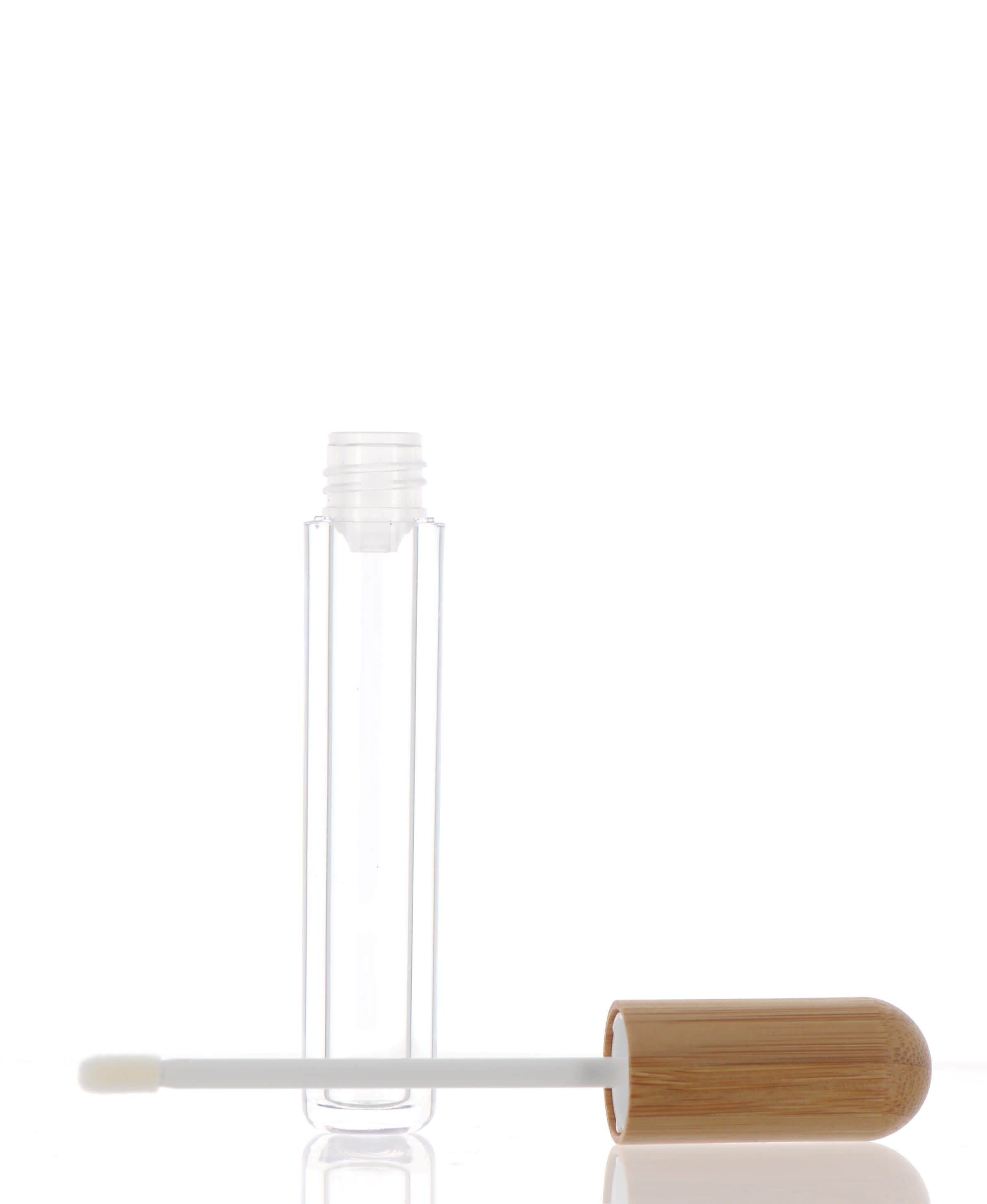 The image shows the APG Packaging 0.2oz Mixed Material Lip Gloss Tube (APG-SY-LG255). The lip gloss tube features a sleek, transparent body that allows the product inside to be visible. It is topped with a shiny, metallic cap that adds a touch of elegance to the design. The tube is compact and designed for easy application and portability.