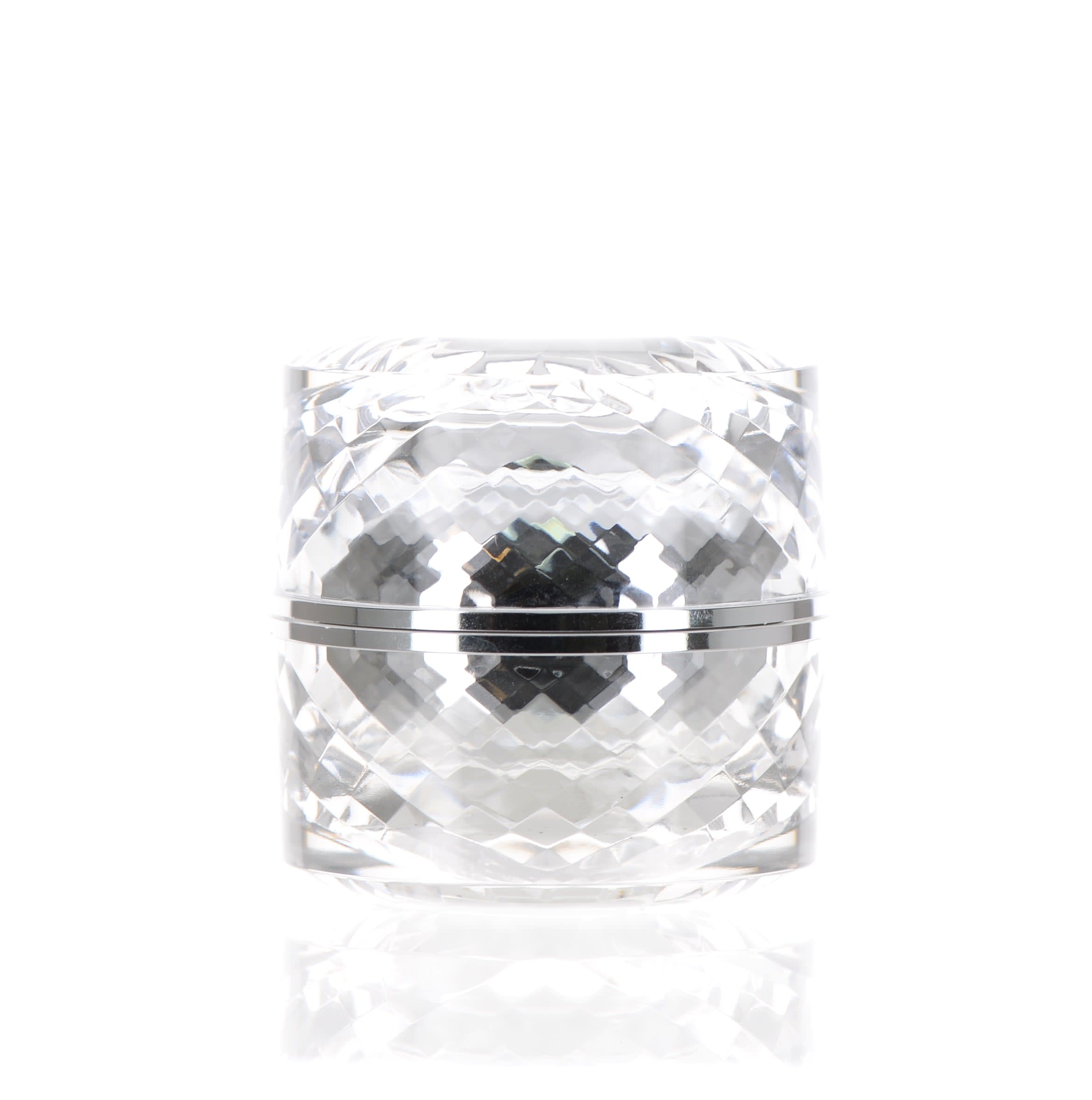 The image features the APG Packaging 1.4oz Mixed Material Jar (APG-50-40_CSW). The jar has a sleek, cylindrical shape with a clear body, allowing the contents inside to be visible. It is topped with a shiny, metallic silver cap that adds a touch of elegance and modern design to the product. The overall appearance is clean and sophisticated, suitable for a variety of cosmetic or skincare products.