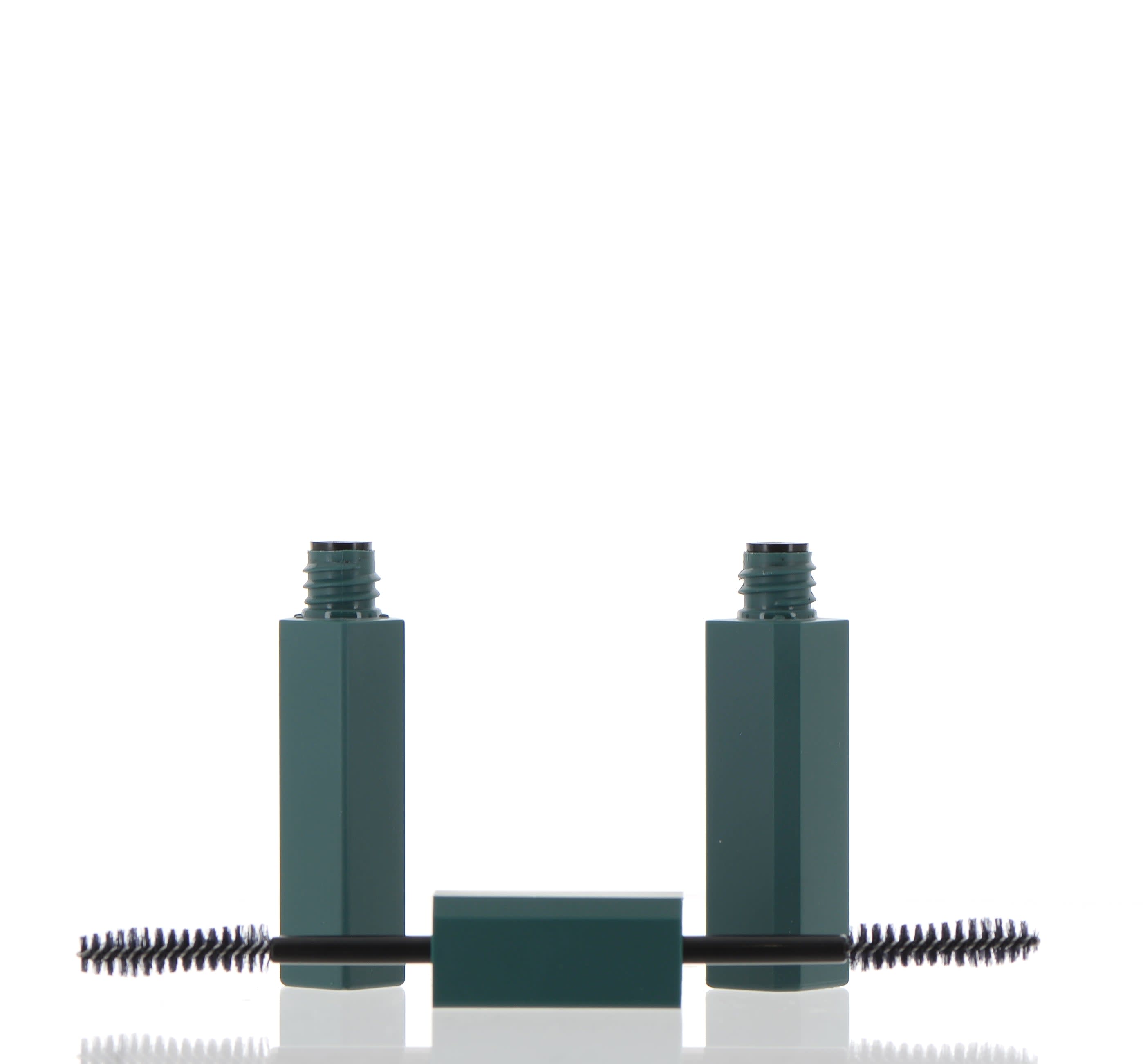 The image shows the APG Packaging 0.3oz Mixed Material Mascara Tube (APG-JA0440-5ML). The product features a sleek, cylindrical design with a smooth, glossy black finish. The tube is capped with a shiny, metallic silver top that contrasts elegantly against the black body. The cap has a fine, ribbed texture that likely provides grip. The overall appearance is modern and sophisticated, suitable for high-end cosmetic packaging.