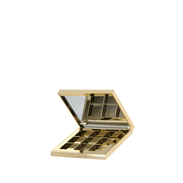 The image displays the APG Packaging 0.0oz Mixed Material Compact (APG-CT-S067-GD). The compact is a sleek, circular container with a metallic gold finish. The top lid is smooth and reflective, giving it a polished appearance. The bottom part of the compact is also gold, matching the lid, and features a subtle texture that enhances the grip. The compact is shown closed, highlighting its elegant and modern design. 