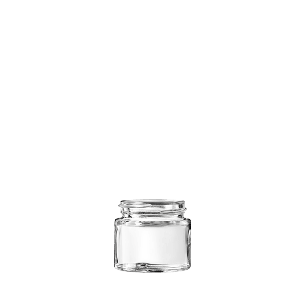 The image shows the Calaso 1.0oz Glass Jar by Glasmeister. The jar is made of clear glass, allowing the contents to be visible. It has a cylindrical shape with a wide mouth, making it suitable for storing creams, balms, or other cosmetic products. The jar is topped with a screw-on lid, which appears to be made of a matte black material. This clean and minimalist design offers both functionality and aesthetic appeal.