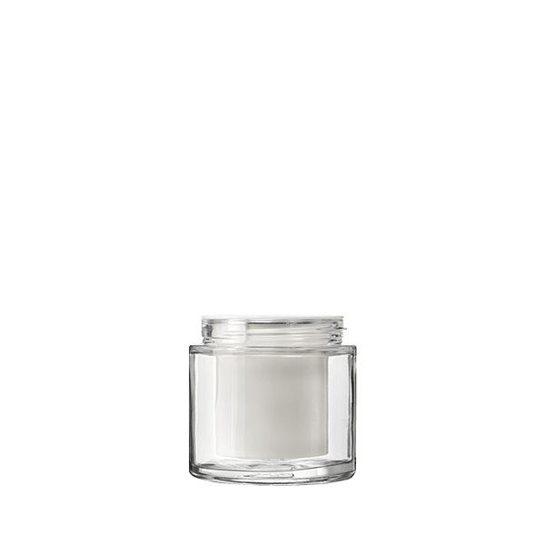 The image features the Calaso 3.3oz Glass Jar HD13815-100. The jar is made of clear glass and has a cylindrical shape with smooth, straight sides. The mouth of the jar is wide and it is topped with a simple, flat, screw-on lid. The design is minimalist and elegant, showcasing the clean lines and transparency of the glass. There are no labels or markings on the jar, giving it a sleek and versatile appearance.