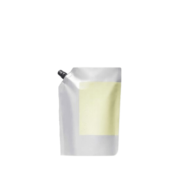 The image shows the Identipak 8.5oz PE Pouch Spouted Refill Pouch, 250ml. The pouch is predominantly white with a clean, minimalist design. It has a spout at the top right corner for easy dispensing of its contents. The overall shape of the pouch is rectangular with a slight taper towards the top. There are no visible labels or text on the pouch in the image provided. The spout is fitted with a cap to ensure the contents are securely sealed. The pouch appears to be freestanding due to its flat bottom design.