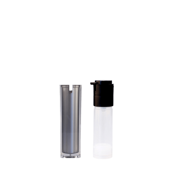 The image shows the Garrett Hewitt International 1.7oz Acrylic Airless Bottle. The bottle has a sleek, cylindrical design with a clear acrylic exterior that showcases a white inner container. It features a silver pump dispenser and a matching silver cap. The overall design is modern and elegant, making it suitable for high-end cosmetic products.