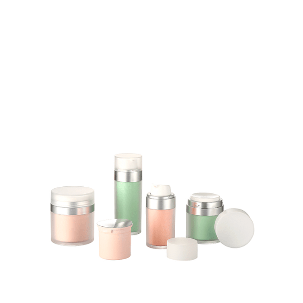 The image shows the Garrett Hewitt International 0.5oz PMMA Airless Jar (GRG-15). The product is a small, cylindrical jar with a sleek and modern design. It features a clear outer shell and a white inner container, providing a clean and minimalist appearance. The jar has a smooth, rounded cap that fits securely on top, ensuring an airtight seal. This airless jar is designed to protect the contents from contamination and oxidation.