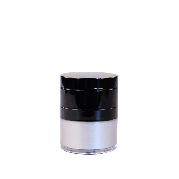 The image shows a Garrett Hewitt International 0.5oz ABS Airless Jar (GRI-15). The jar has a sleek, cylindrical design with a glossy white finish. It features a clear, transparent lid that fits snugly over the main body of the jar. The airless pump mechanism is visible through the lid, ensuring the product inside is well-preserved. The overall appearance is modern and elegant, suitable for high-end cosmetic or skincare products.