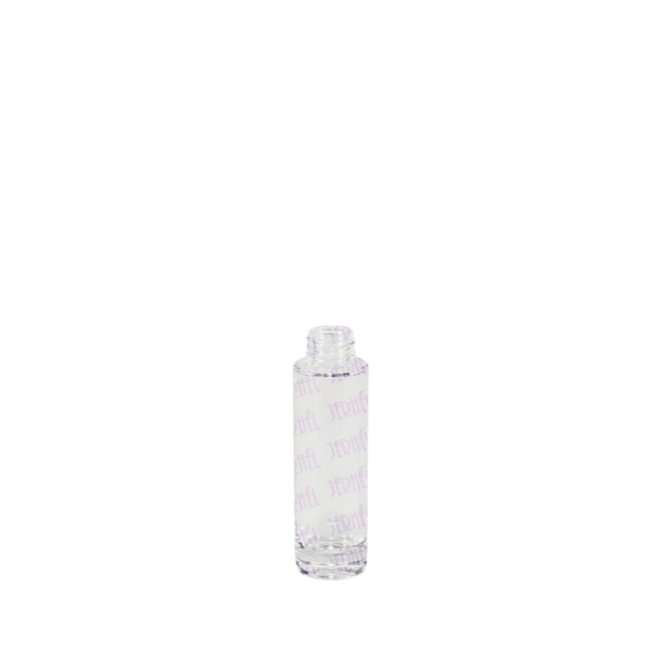The image shows the Jerhel Plastics Inc. 0.7oz Glass Bottle (JI-23785). The bottle is small and cylindrical with a clear glass body and a screw-on cap. The cap appears to be metallic, providing a sleek and modern look. The bottle is empty, highlighting its transparent nature, and is designed to hold a small amount of liquid, suitable for travel-sized products or samples.