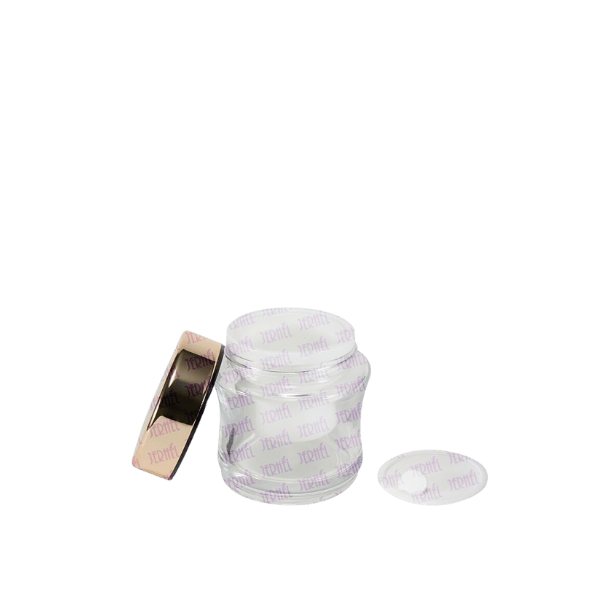 The image displays the Jerhel Plastics Inc. 1.7oz Glass Jar JI-2194. It is a clear, cylindrical glass jar with a smooth, transparent body and a wide opening at the top. The lid is not shown in the image. The jar appears to be empty, showcasing its pristine and clean design.
