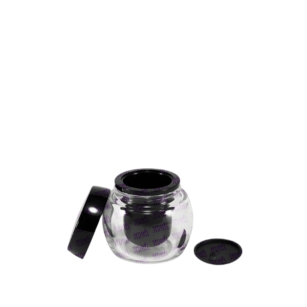 The image displays the Jerhel Plastics Inc. 1.7oz Glass Jar (JI-2195). It features a clear, round glass container with a wide mouth and a smooth finish. The jar is capped with a flat, metallic lid that appears to be silver in color. The design is simple and elegant, suitable for storing cosmetics or other small items. The transparent body allows the contents to be visible, while the sturdy construction suggests durability.