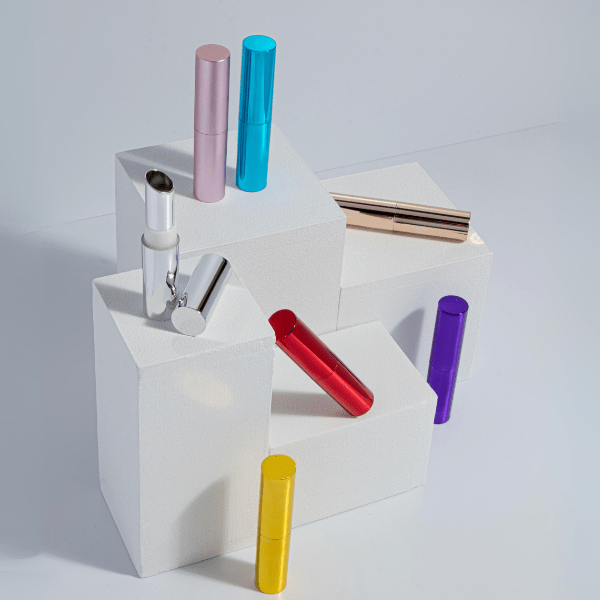 The image shows the SIMEX ABS Lipstick LB002. It is a sleek, cylindrical lipstick tube with a glossy black finish. The cap, which is also black with a shiny surface, is placed beside the base of the lipstick, revealing the mechanism that holds the lipstick bullet. The overall design is modern and elegant, making it an appealing choice for cosmetic packaging.