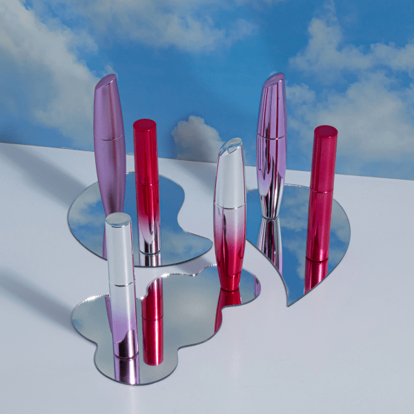 The image shows the Simex 0.3oz ABS Mascara Tube MA015. The product is a sleek, cylindrical mascara tube with a glossy black finish. The tube features a smooth surface and a slightly tapered design towards the cap. The cap is also black and seamlessly blends with the tube, giving it a uniform and elegant appearance. The overall design is minimalistic and modern, suitable for a high-end cosmetic product.