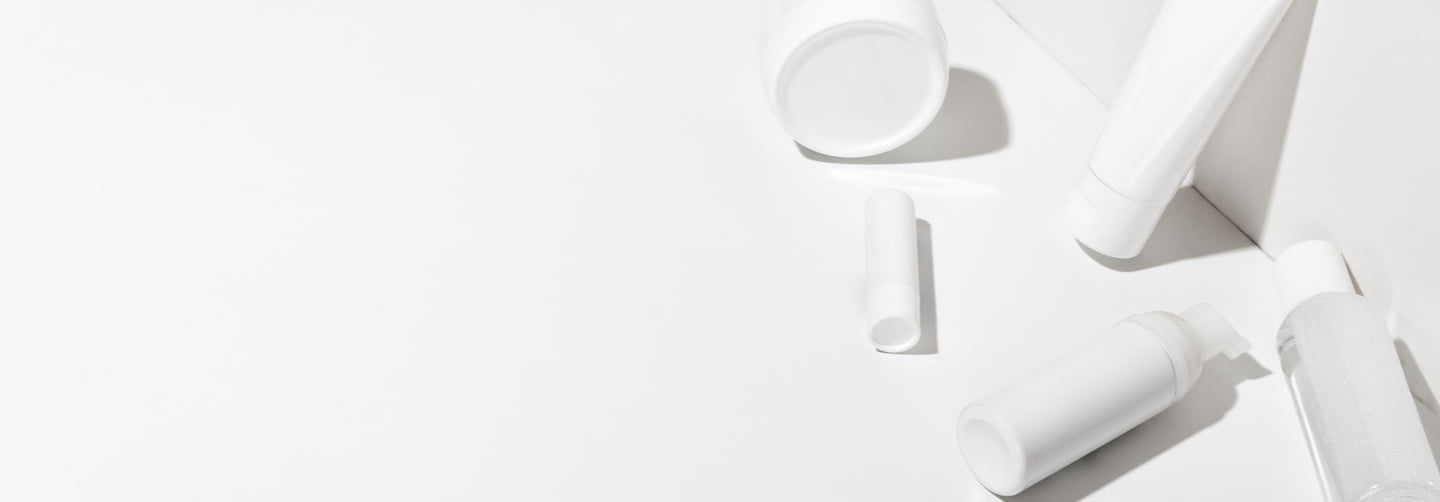 Cosmetic packaging bottles, jars and tubes pictured on a neutral background