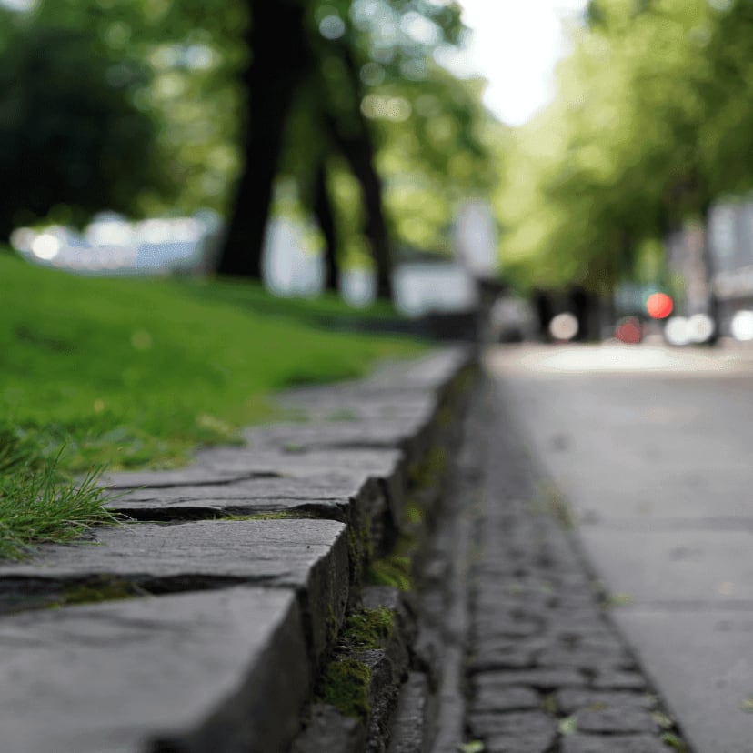 Residential street stone curb and lawn