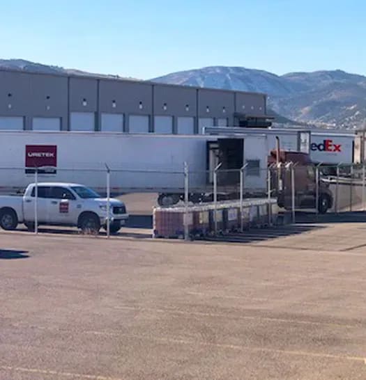 URETEK warehouse on lot with mountains in background