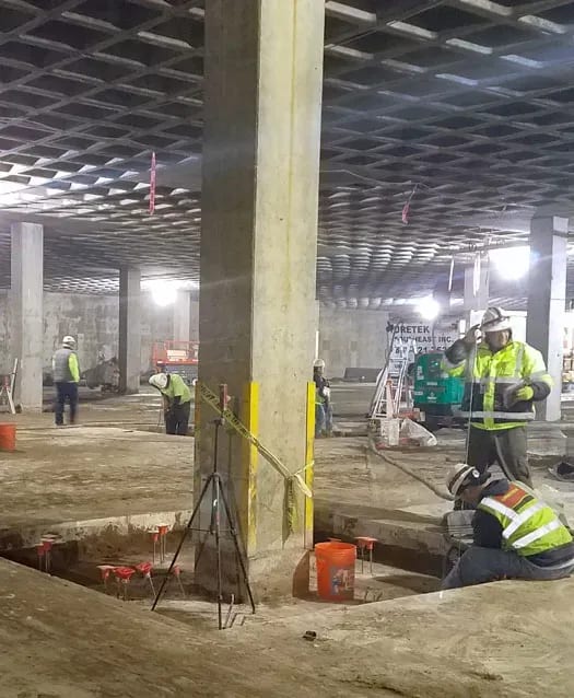 URETEK technicians at work on parking lot beam