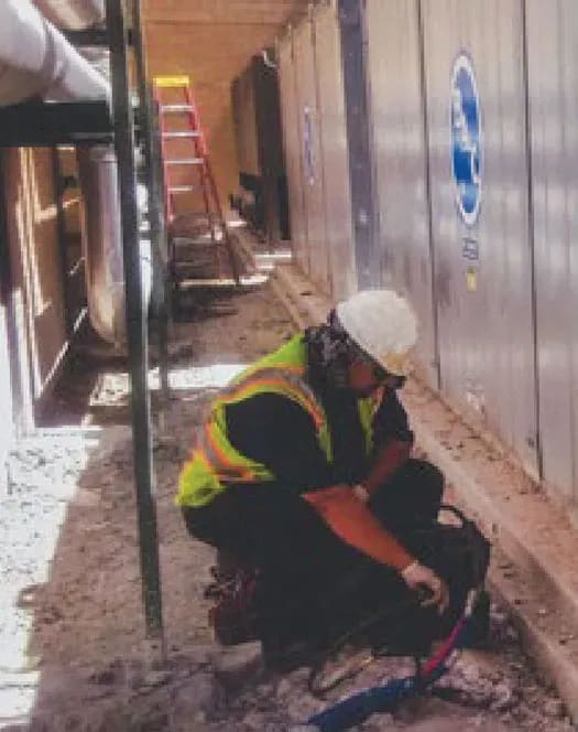 URETEK technician stabilizing wall