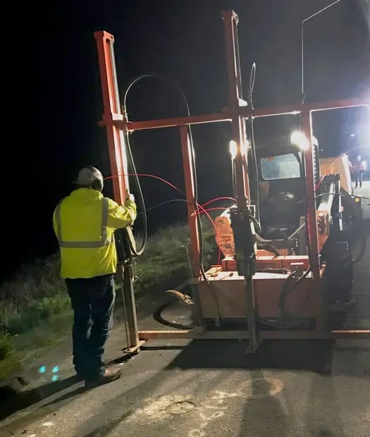 URETEK technician bulding a structure at night