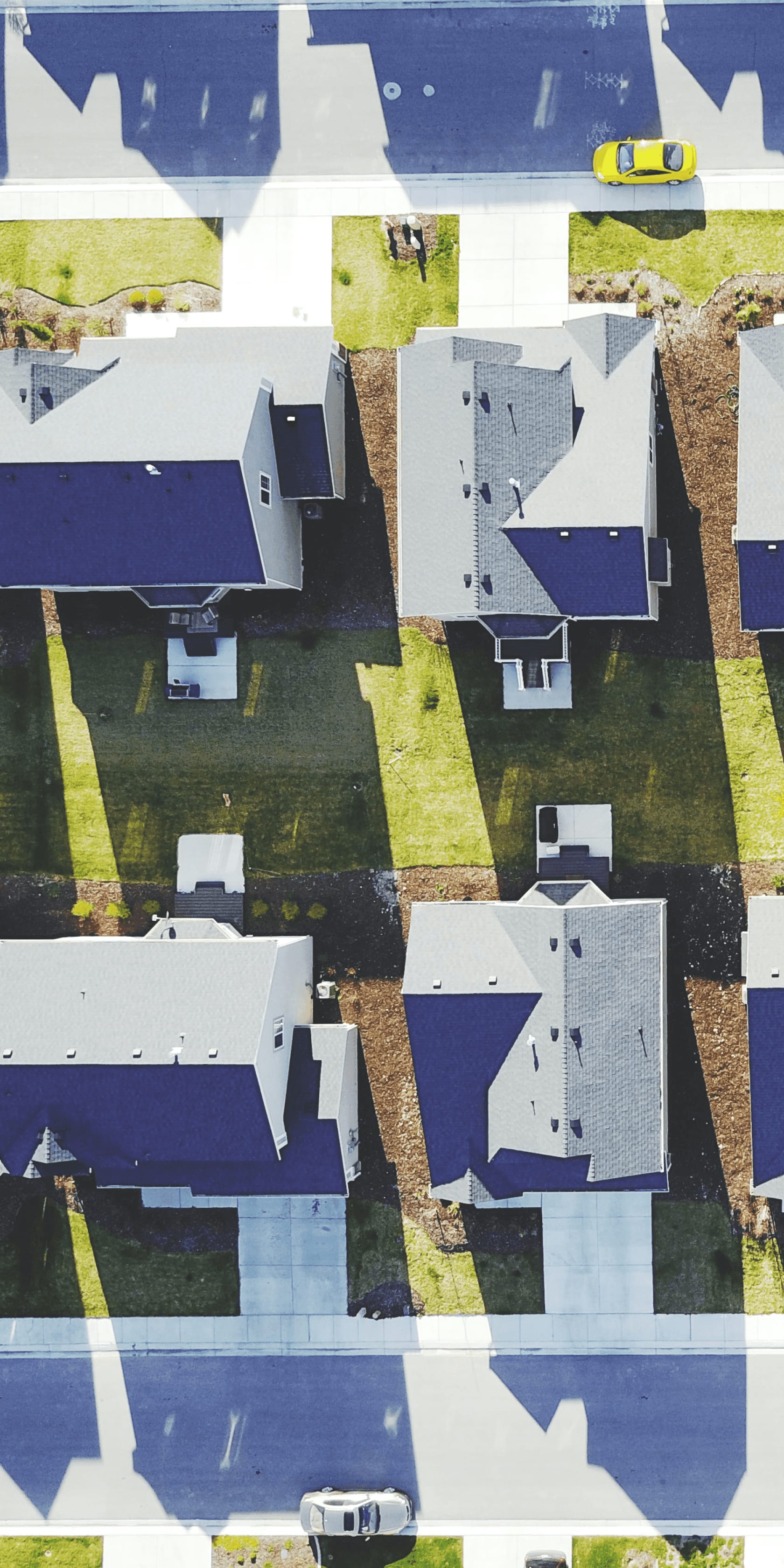 Aerial shot of residential street with driveways and street