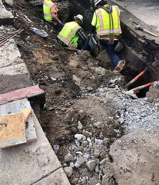Three technicians in gash in ground