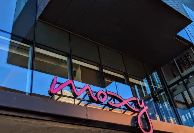 Restaurant sign reading "moxy"