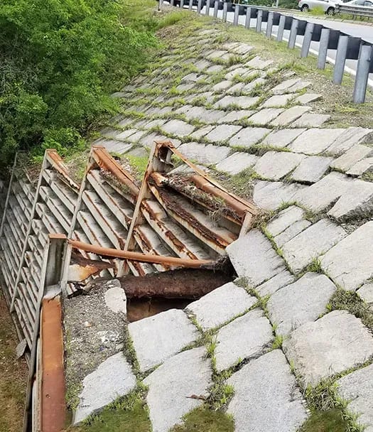 Sloped stone wall next to highway