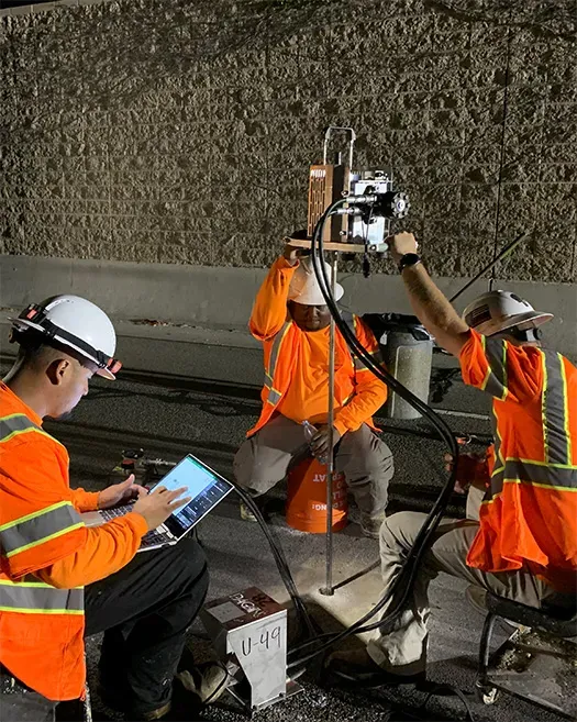 Three URETEK technicians analyze worksite