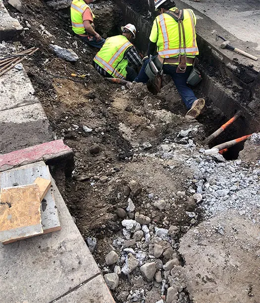 Three technicians in gash in ground