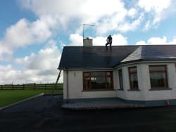 Asbestos slate roof being refurbished with acylic coloured sealer bring it back to it former glory this roof was 27yrs old