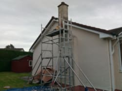 Old roughcast removed on chimney breast and redone to match existing roughcast