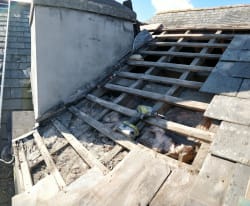 Poor slate condition and incorrect sized slates allowing water ingress down chimney wall.stripped right back and rebuilt within the day.