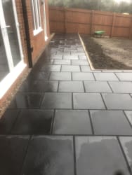 This is a Indian sandstone patio completed in black limestone 