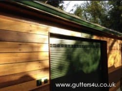 Bottle green seamless aluminium gutter colour matched to existing garage door