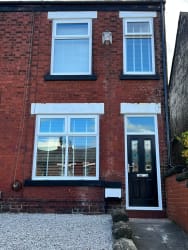 UPVC white windows and a black composite door