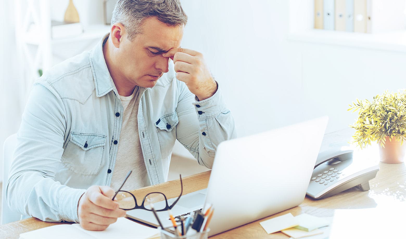 A man looking frustrated at his computer screen