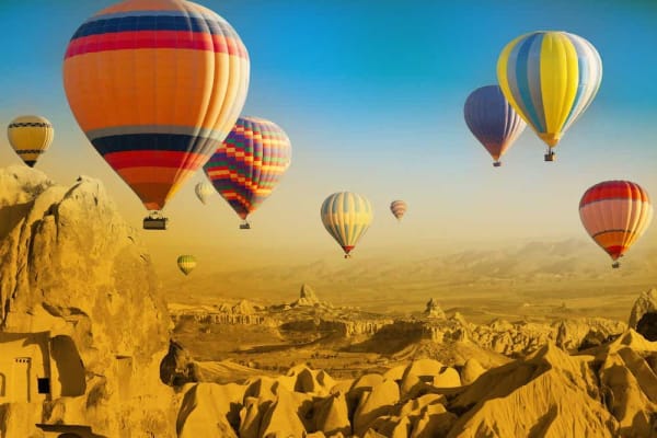 Hot air balloons over a rocky landscape