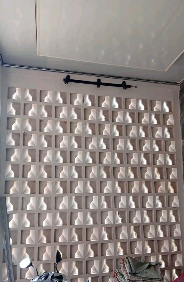 The implementation of minimalist $breeze$ $block$ on the facade of modern house architecture provides optimal ventilation and creates an aesthetically pleasing decorative roster.