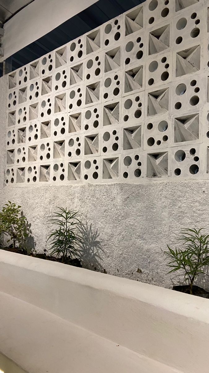 The implementation of minimalist $breeze$ $block$ on the facade of modern house architecture provides optimal ventilation and creates an aesthetically pleasing decorative roster.