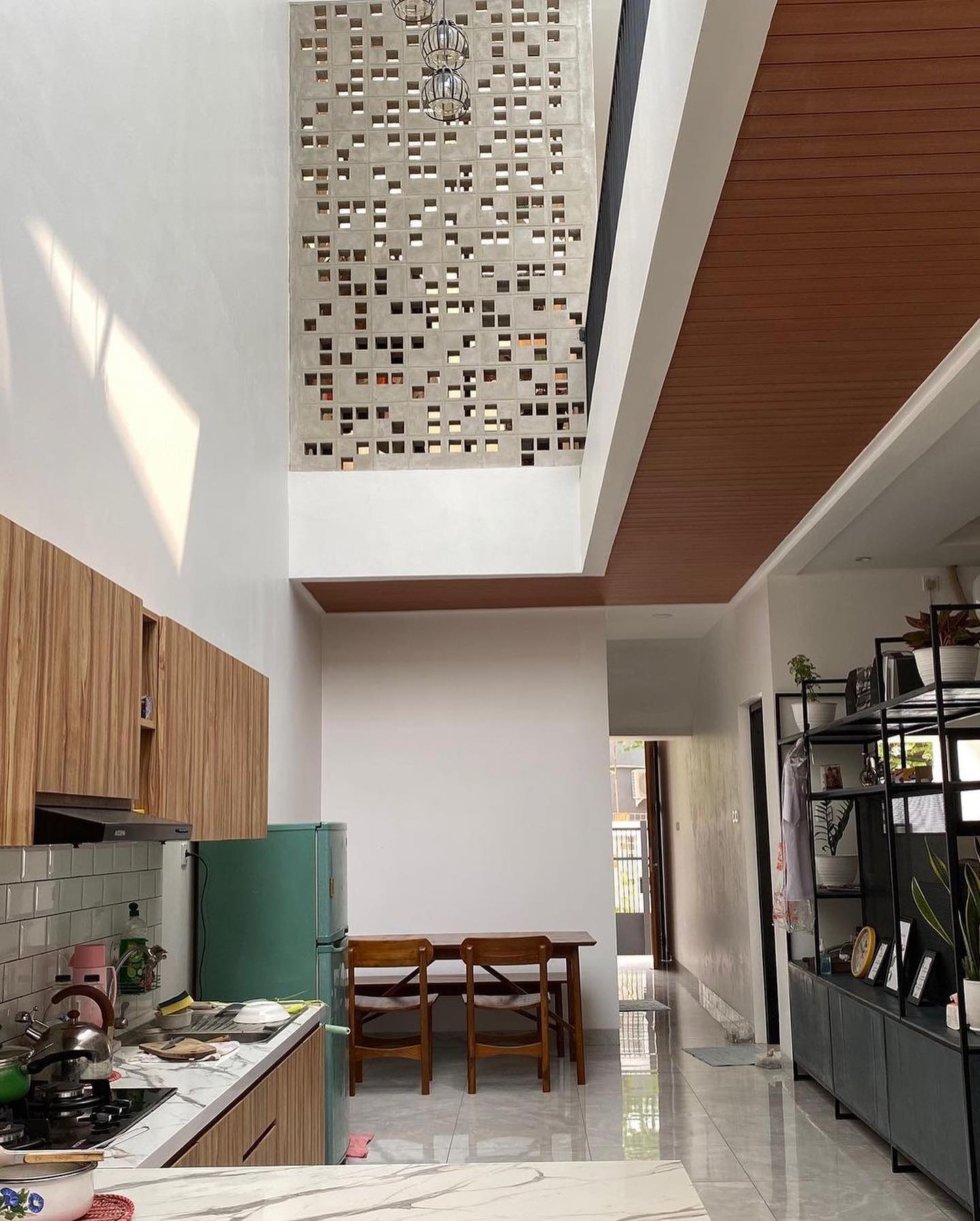 The implementation of minimalist $breeze$ $block$ on the facade of modern house architecture provides optimal ventilation and creates an aesthetically pleasing decorative roster.