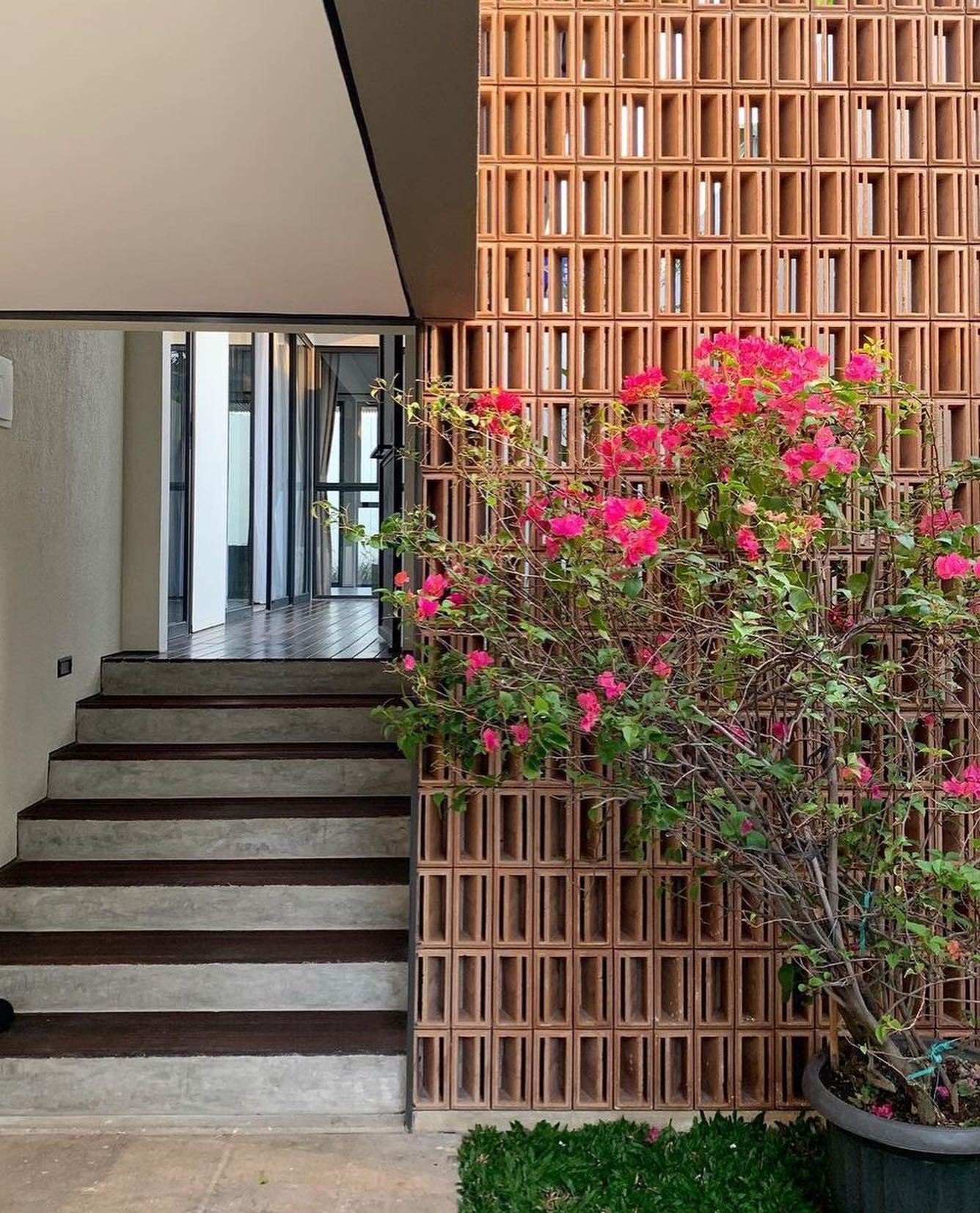 The implementation of minimalist $breeze$ $block$ on the facade of modern house architecture provides optimal ventilation and creates an aesthetically pleasing decorative roster.