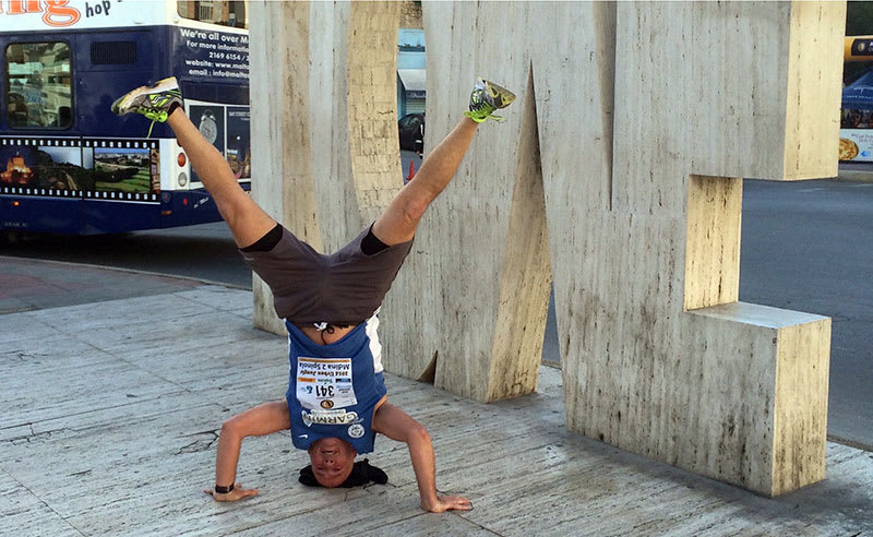 Andrew Mackay in a headstand at the LOVE statue (also upside down) in St. Julian's, Malta