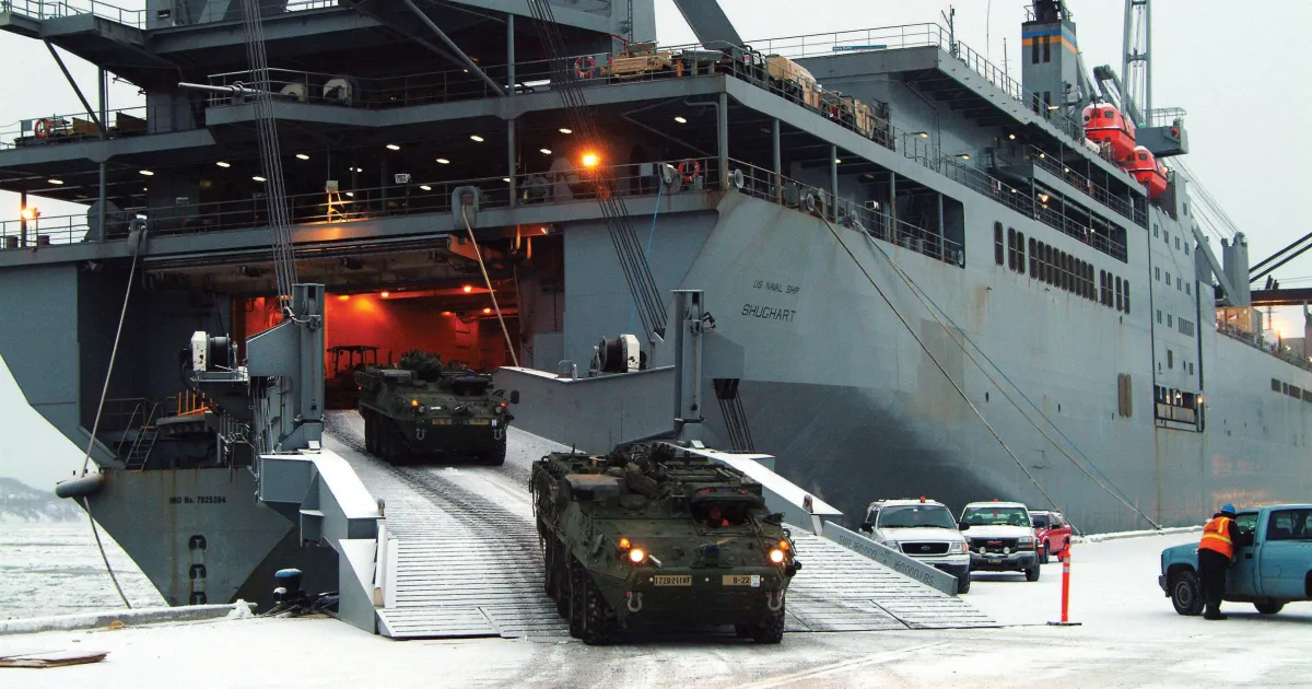 A military ro-ro vessel loading armored personnel carriers