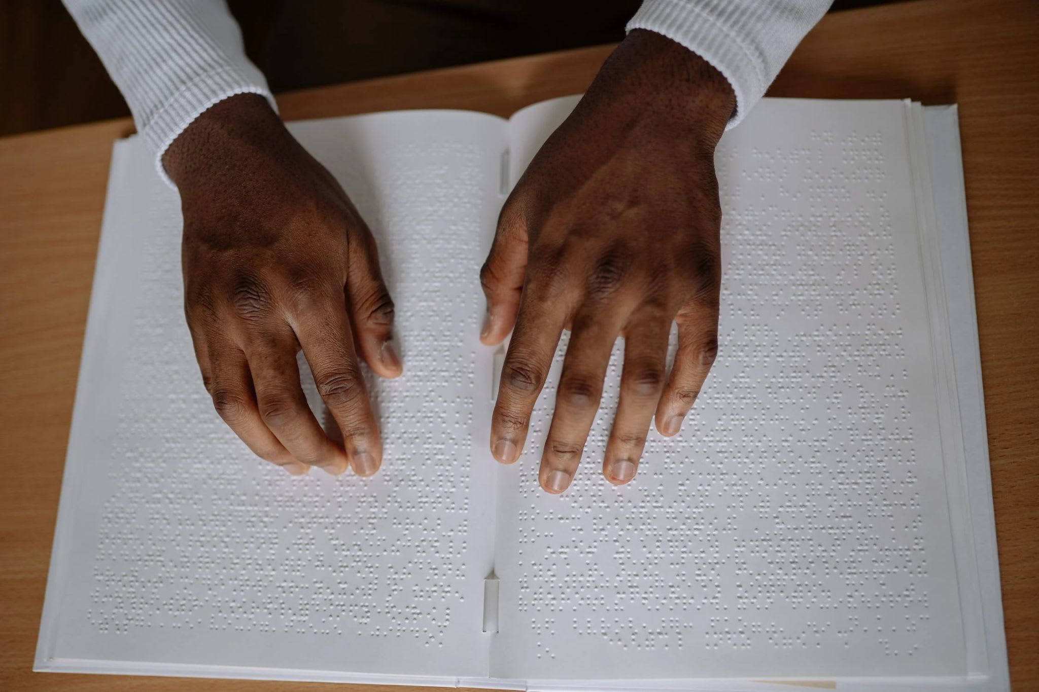 A Person Touching a Braille Book, a photo by Yan Krukov